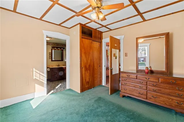a view of a room with cabinet mirror and a bathtub