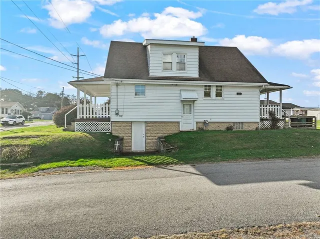 a front view of house with yard and green space