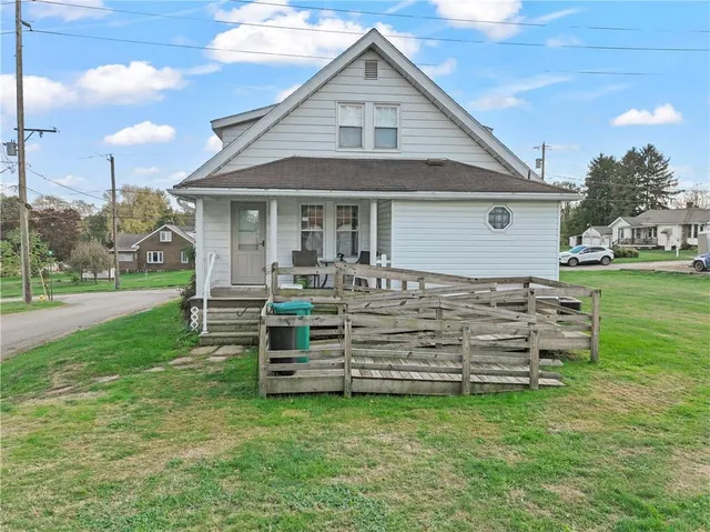 a front view of a house with a garden