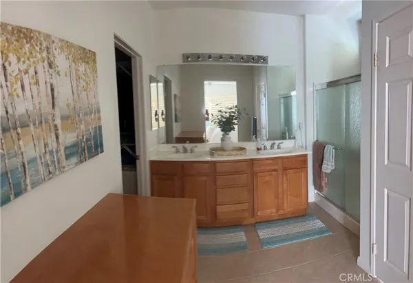 a bathroom with a sink double vanity and a mirror