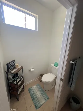 a bathroom with a sink toilet and window