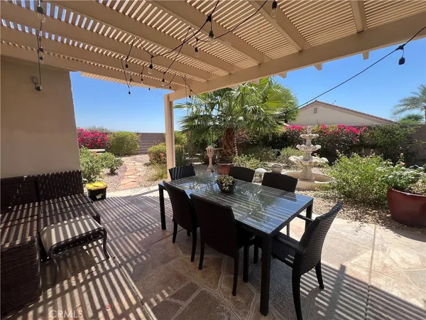 a view of a patio with a table and chairs