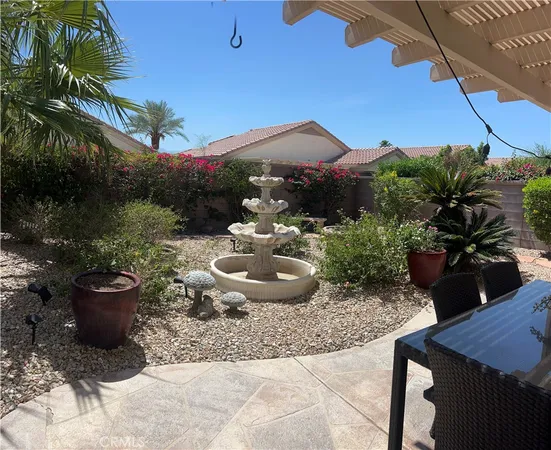 a view of a backyard with plants and a patio