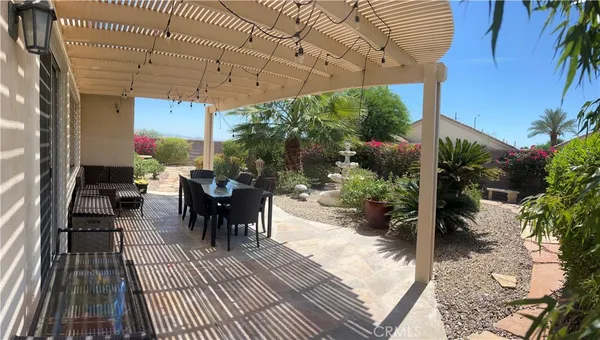 a view of a patio with table and chairs potted plants with wooden floor