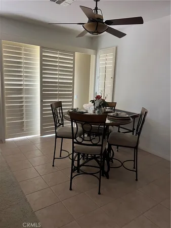 a view of a dining room with furniture and window