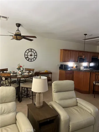 a living room with furniture and a lamp