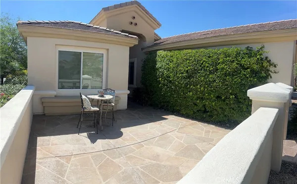 a building outdoor space with patio furniture and potted plants