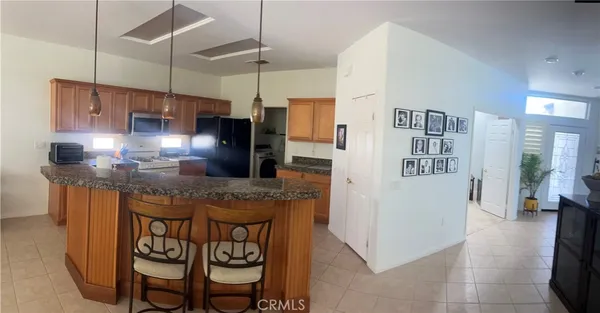 a kitchen with cabinets and wooden floor