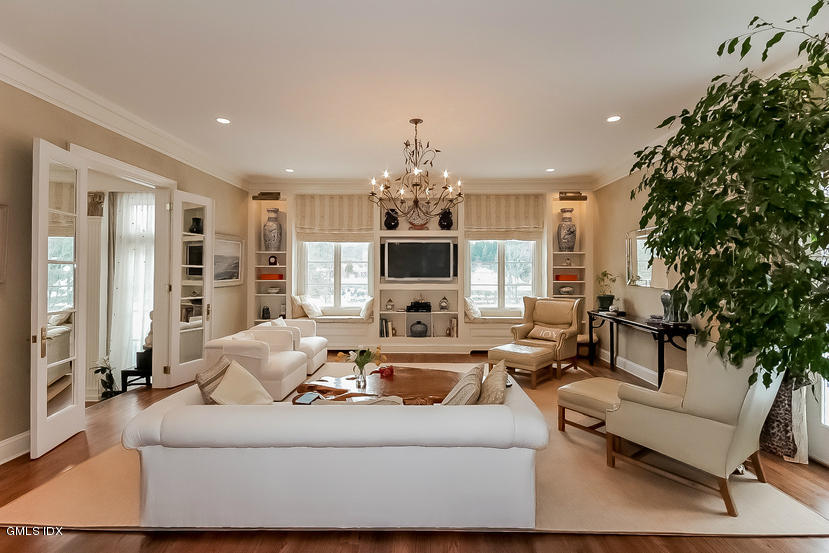 200 Stanwich Road Greenwich, CT 06830 - Photo 11 of 18 a living room with fireplace furniture and a chandelier
