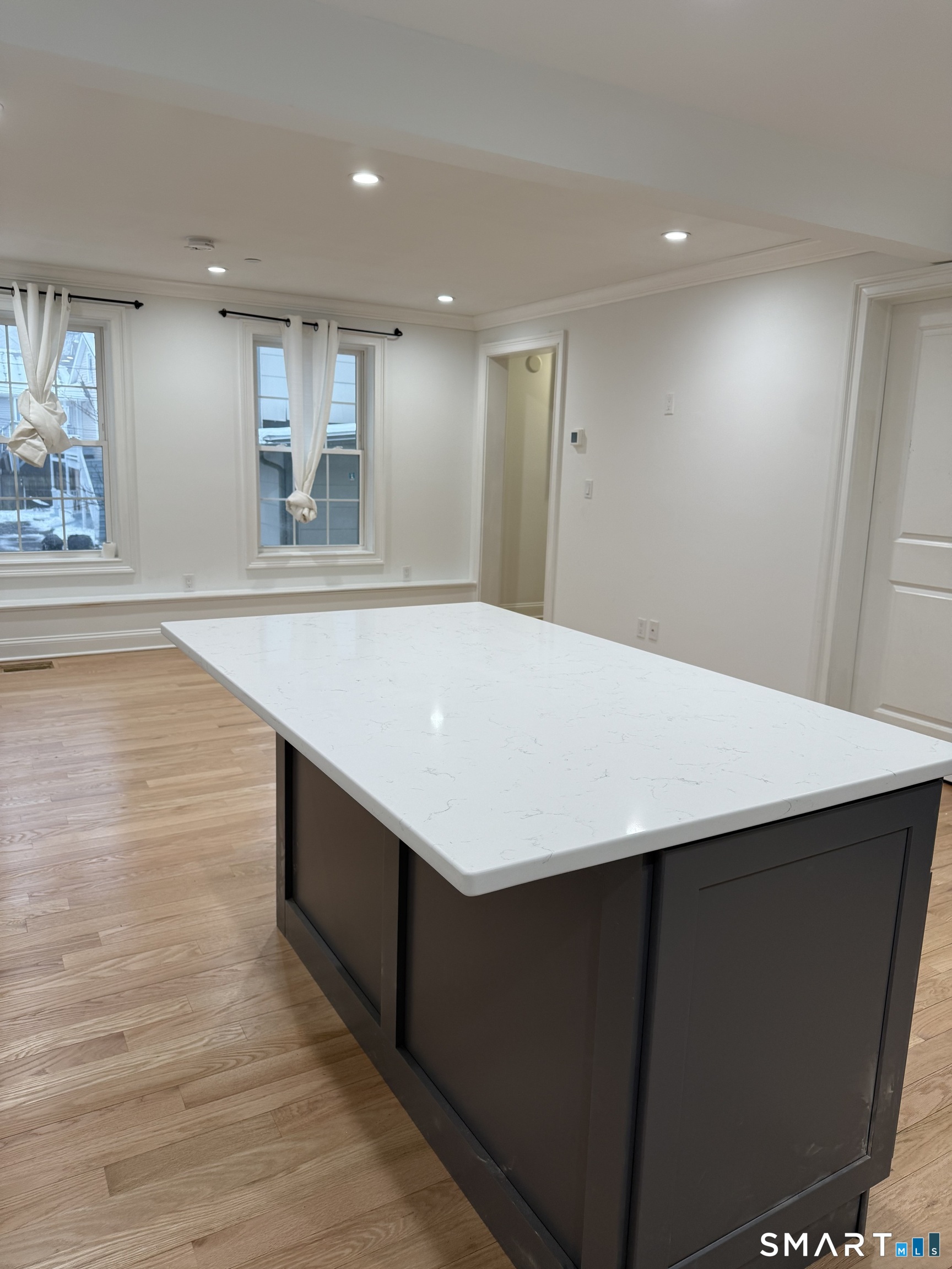 a room with pool table and window
