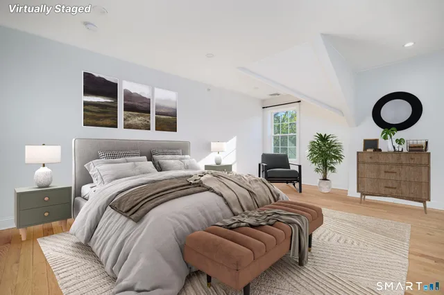 a bedroom with a large bed and a couch