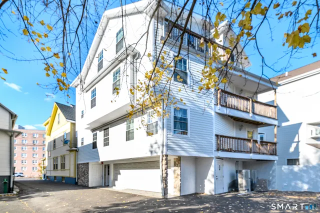 a front view of a building with a tree