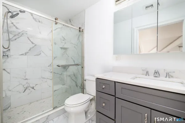 a bathroom with a sink toilet and shower