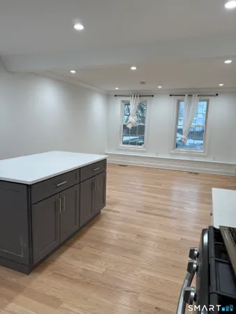 a room with a wooden floor and cabinets