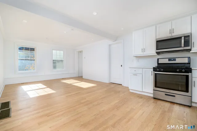 a kitchen with granite countertop a stove and a sink