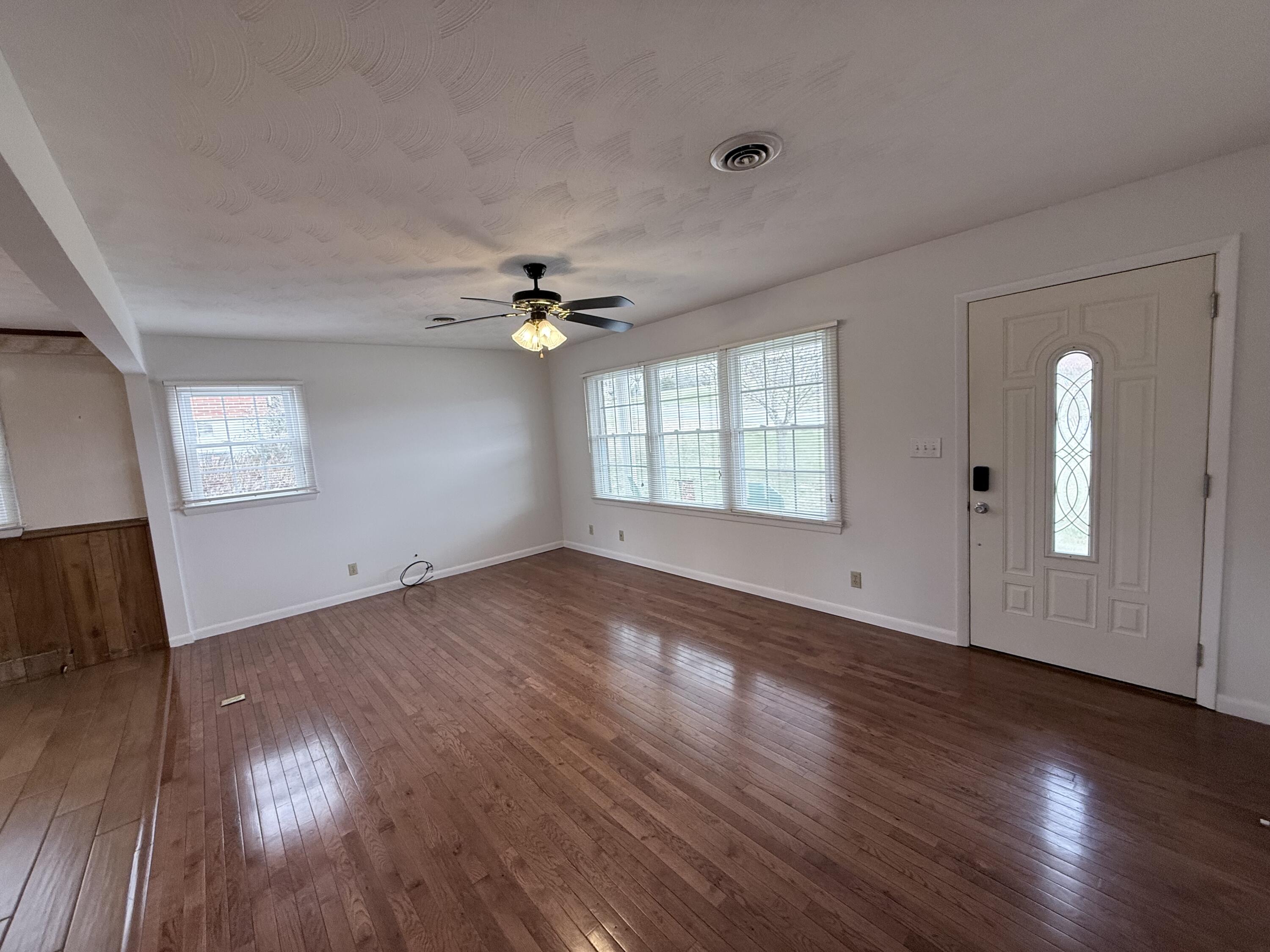 448 Baughman Avenue Marion, VA 24354 - Photo 13 of 43 a view of an empty room with wooden floor and a window