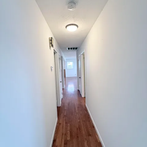 a bathroom with a double vanity sink mirror and toilet