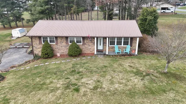 aerial view of a house with yard and sitting area