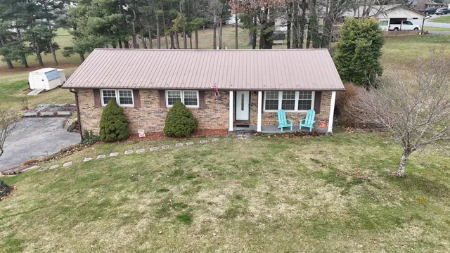 aerial view of a house with yard and sitting area