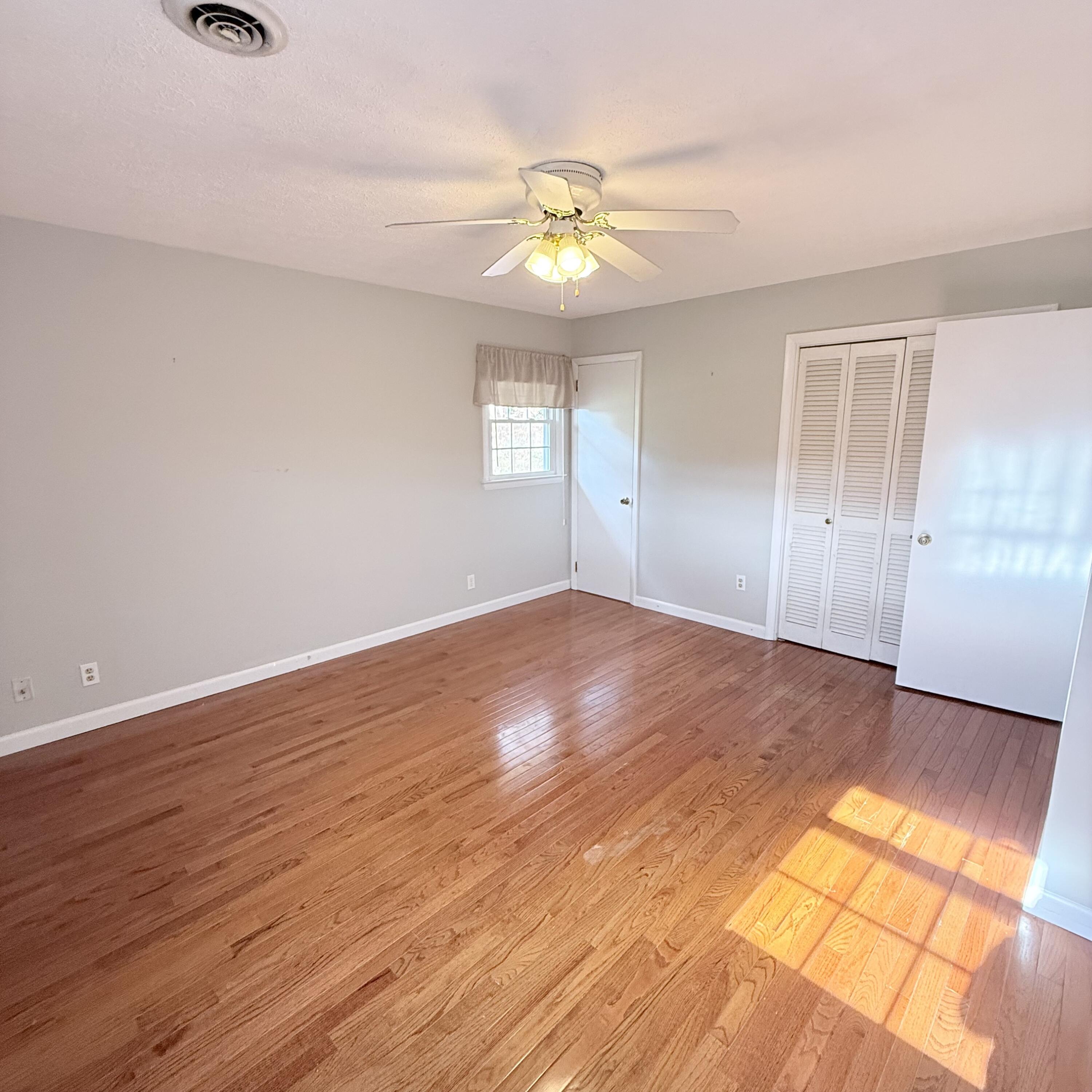 448 Baughman Avenue Marion, VA 24354 - Photo 25 of 43 a view of an empty room with wooden floor and a window