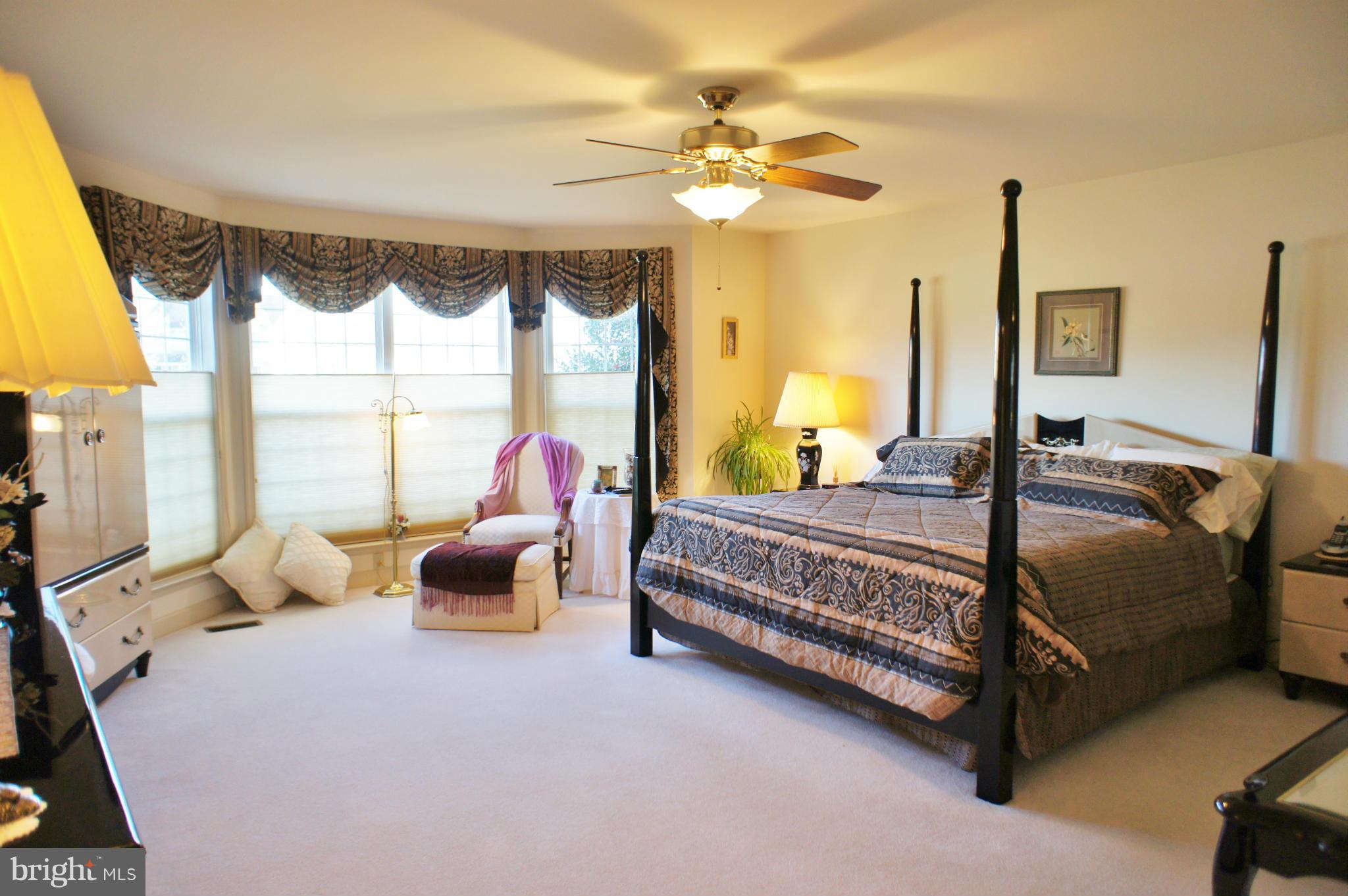 5971 Ketch Road Prince Frederick, MD 20678 - Photo 15 of 30 a bedroom with a bed and large glass window