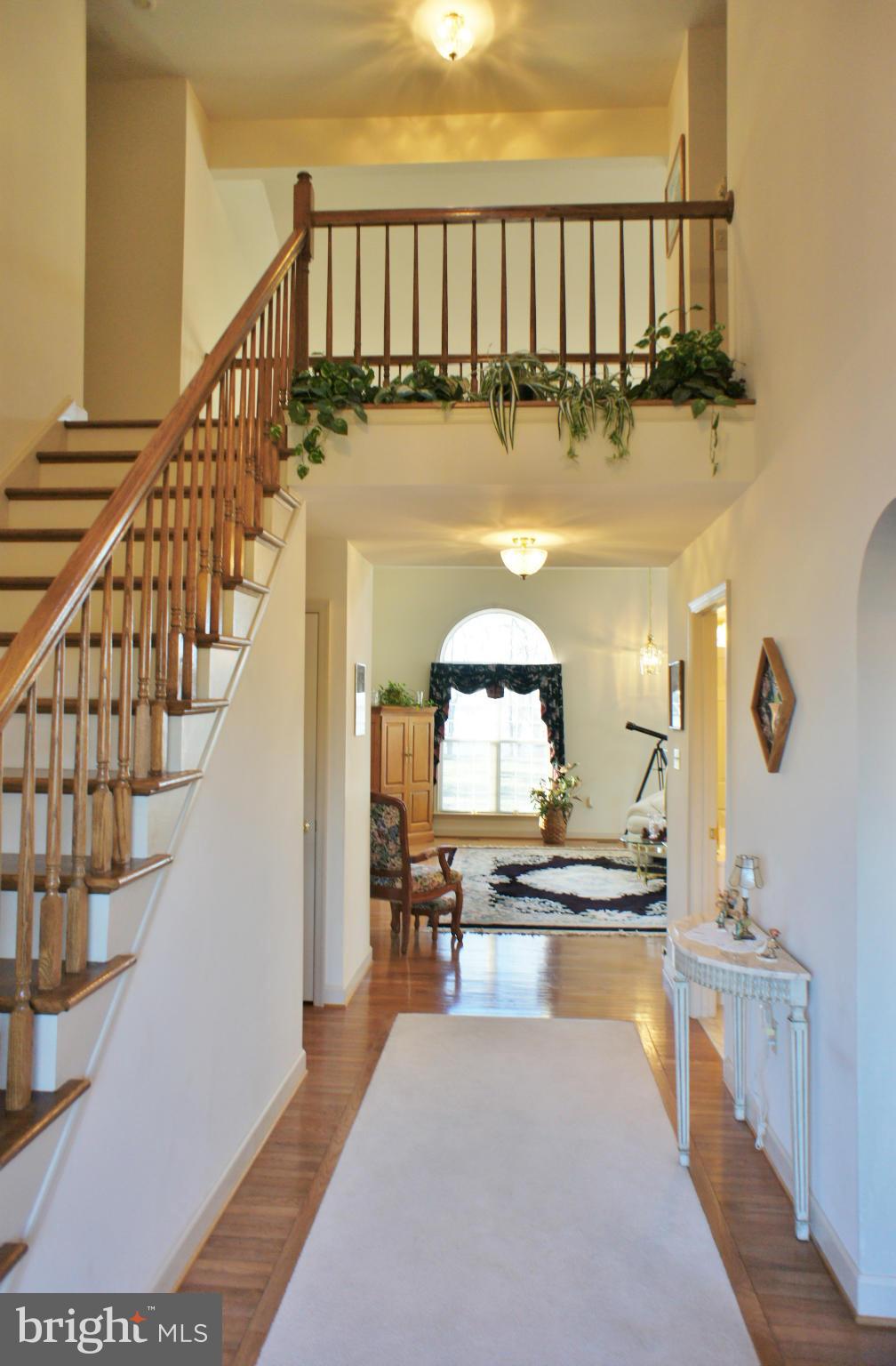 5971 Ketch Road Prince Frederick, MD 20678 - Photo 4 of 30 a view of living room with wooden floor and a view of kitchen