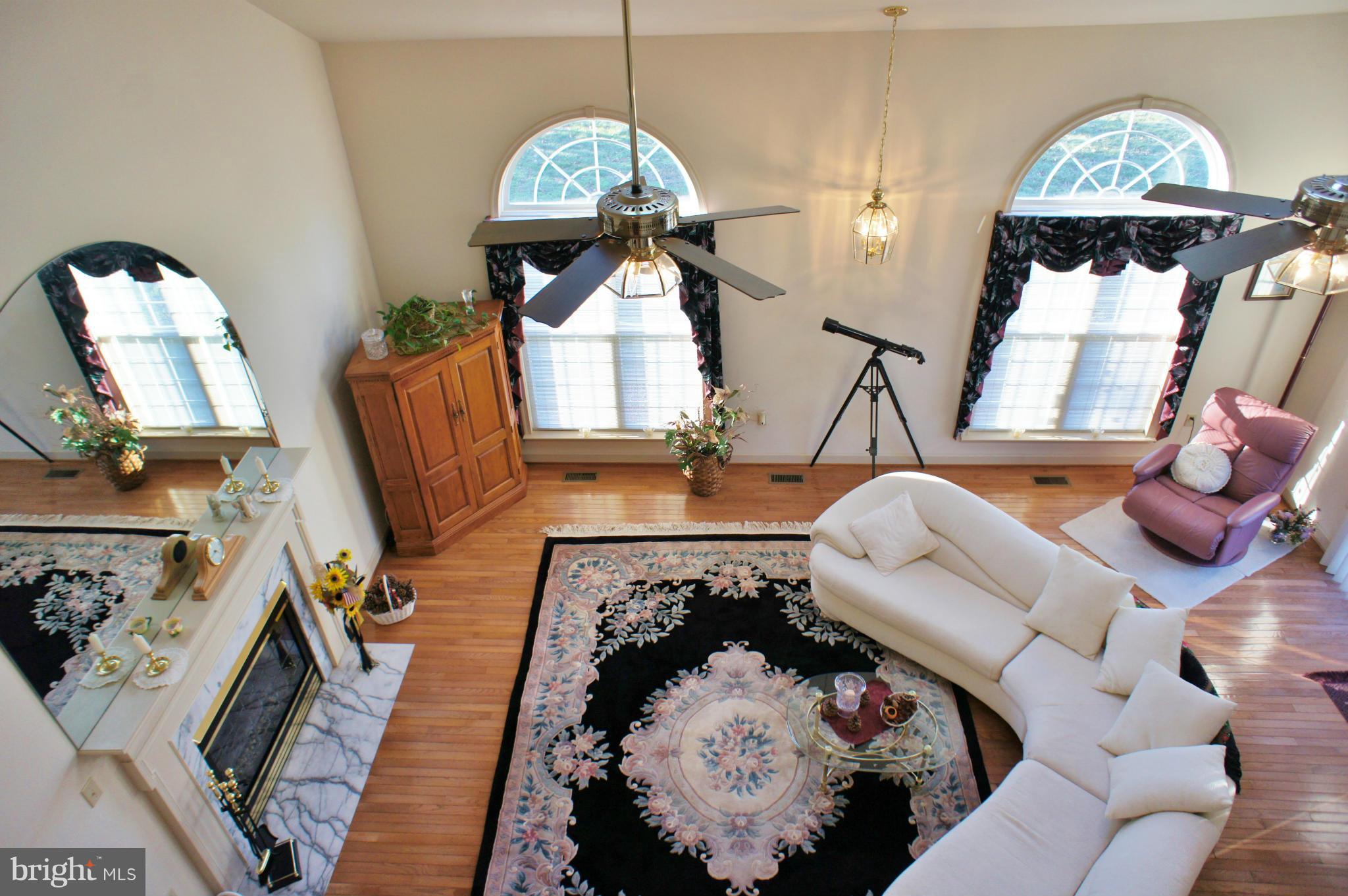 5971 Ketch Road Prince Frederick, MD 20678 - Photo 6 of 30 a living room with furniture fireplace and a large mirror