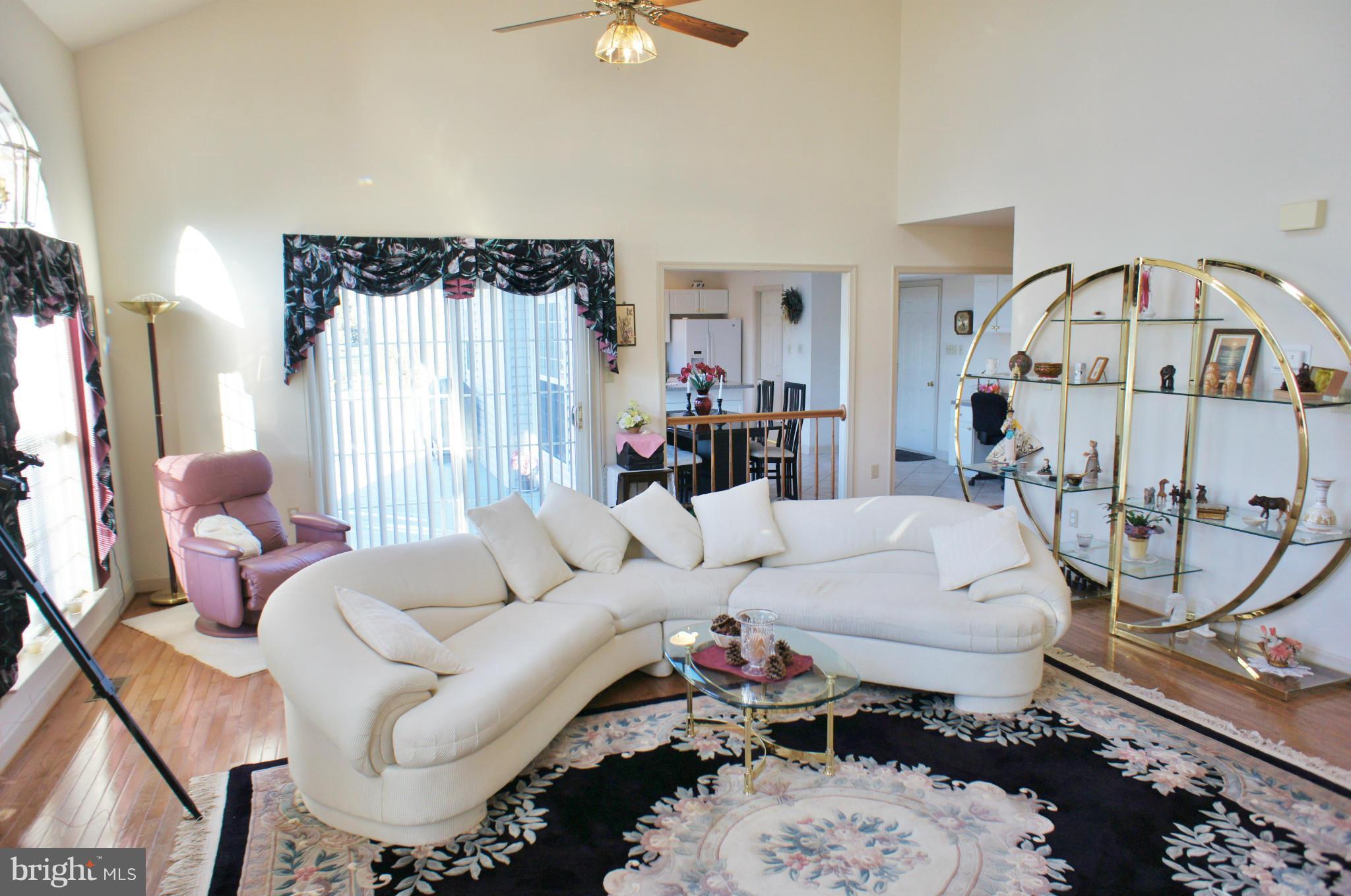5971 Ketch Road Prince Frederick, MD 20678 - Photo 7 of 30 a living room with furniture a couch and a chandelier