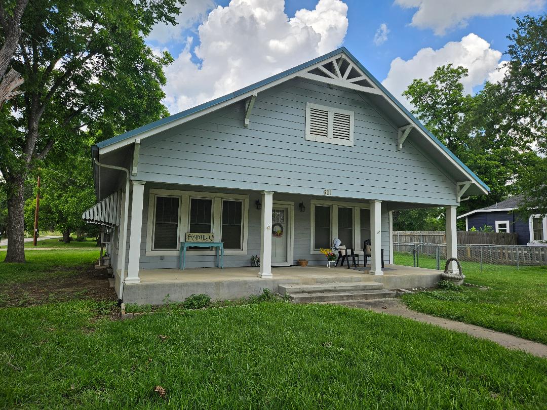 611 North Main Street Elgin, TX 78621 - Photo 1 of 26 a front view of a house with garden and porch