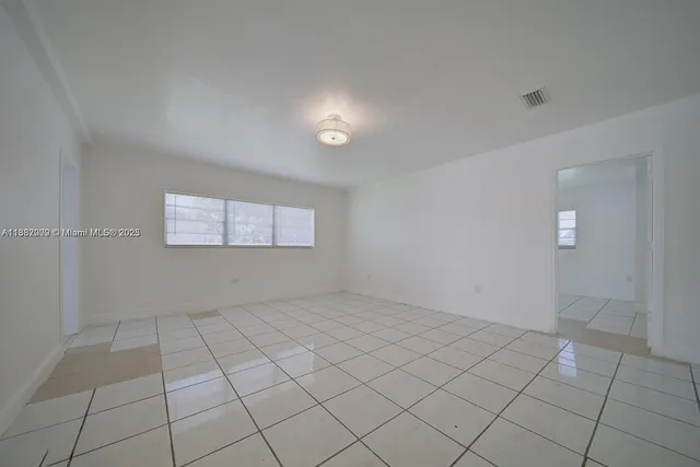 a view of an empty room and window