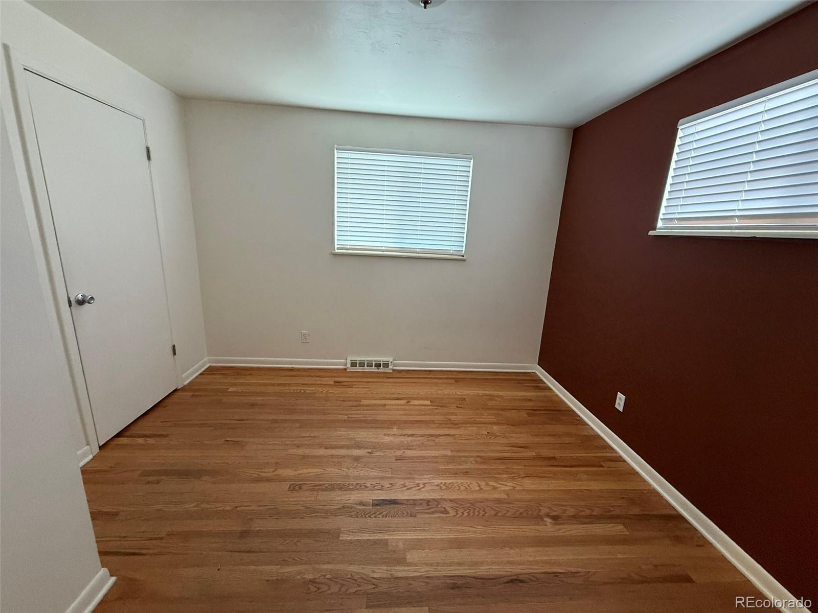 378 South Racine Street Aurora, CO 80012 - Photo 12 of 44 a view of empty room with wooden floor