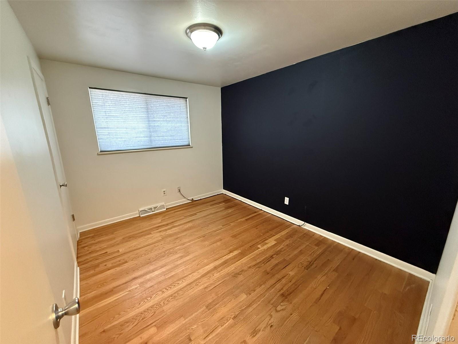 378 South Racine Street Aurora, CO 80012 - Photo 15 of 44 an empty room with wooden floor