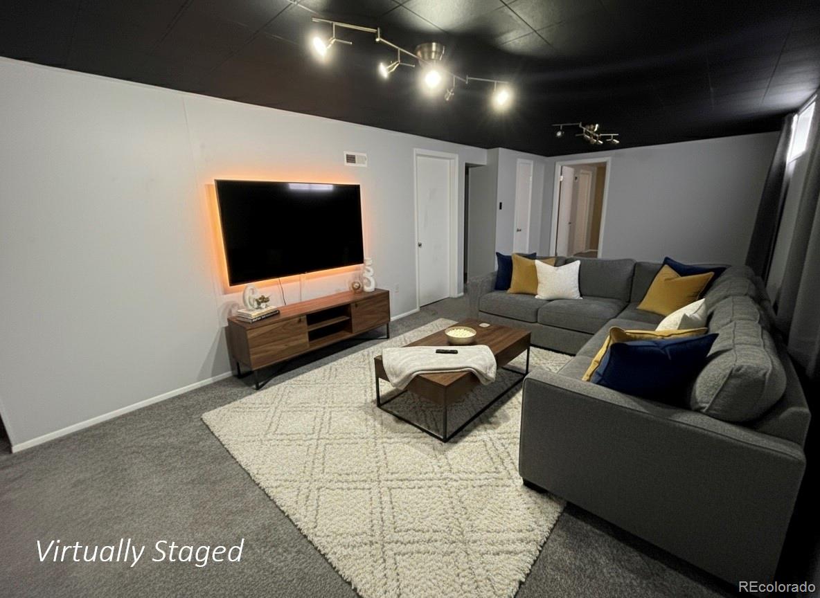 378 South Racine Street Aurora, CO 80012 - Photo 17 of 44 a living room with furniture and a flat screen tv