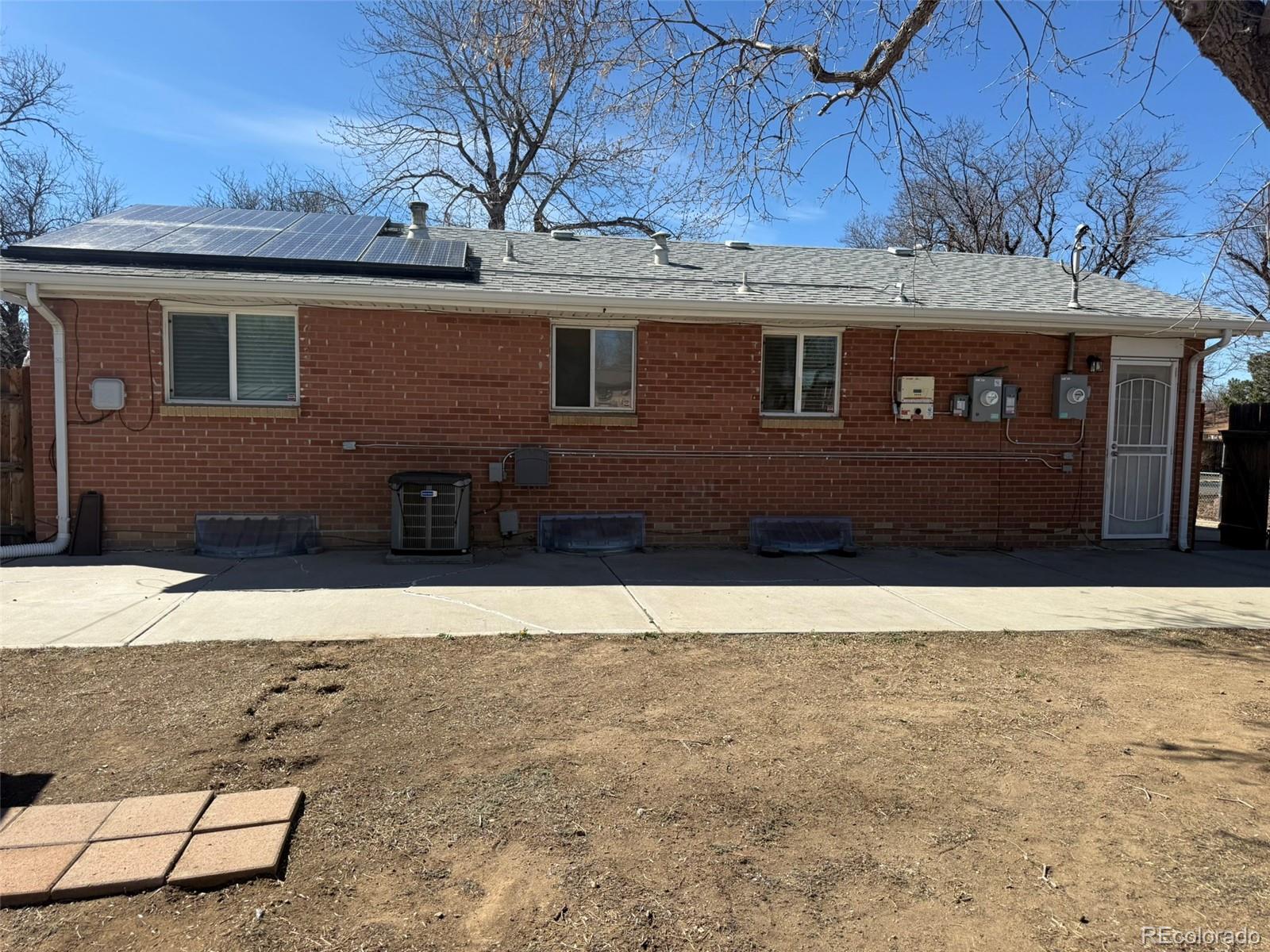 378 South Racine Street Aurora, CO 80012 - Photo 29 of 44 a front view of a house with a yard