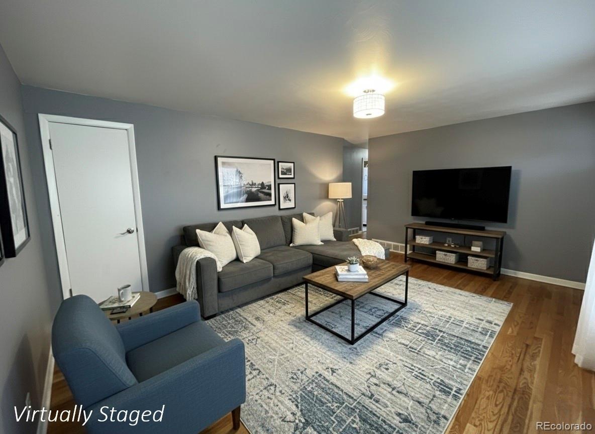 378 South Racine Street Aurora, CO 80012 - Photo 3 of 44 a living room with furniture and a flat screen tv