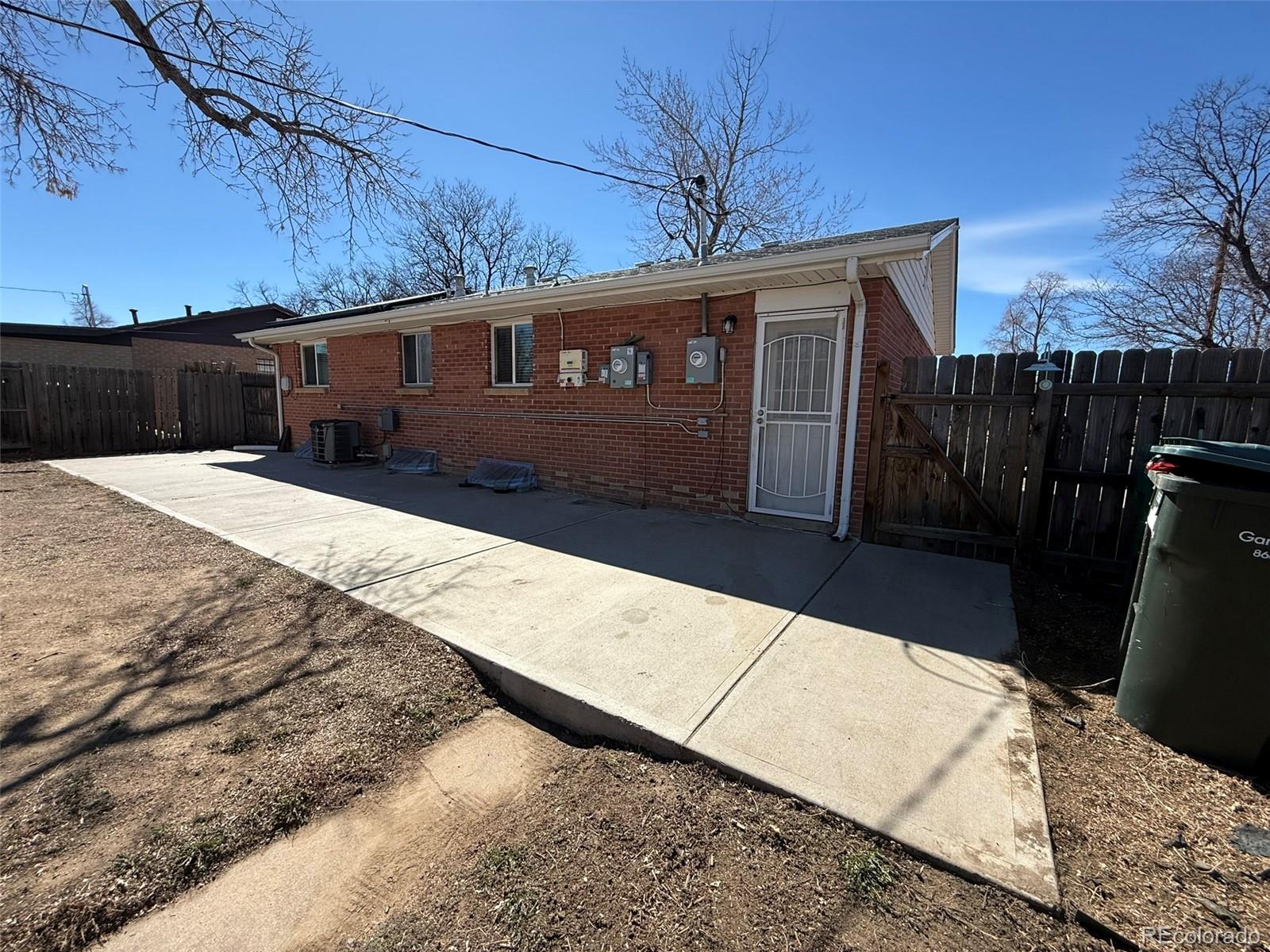 378 South Racine Street Aurora, CO 80012 - Photo 33 of 44 a front view of a house with a yard