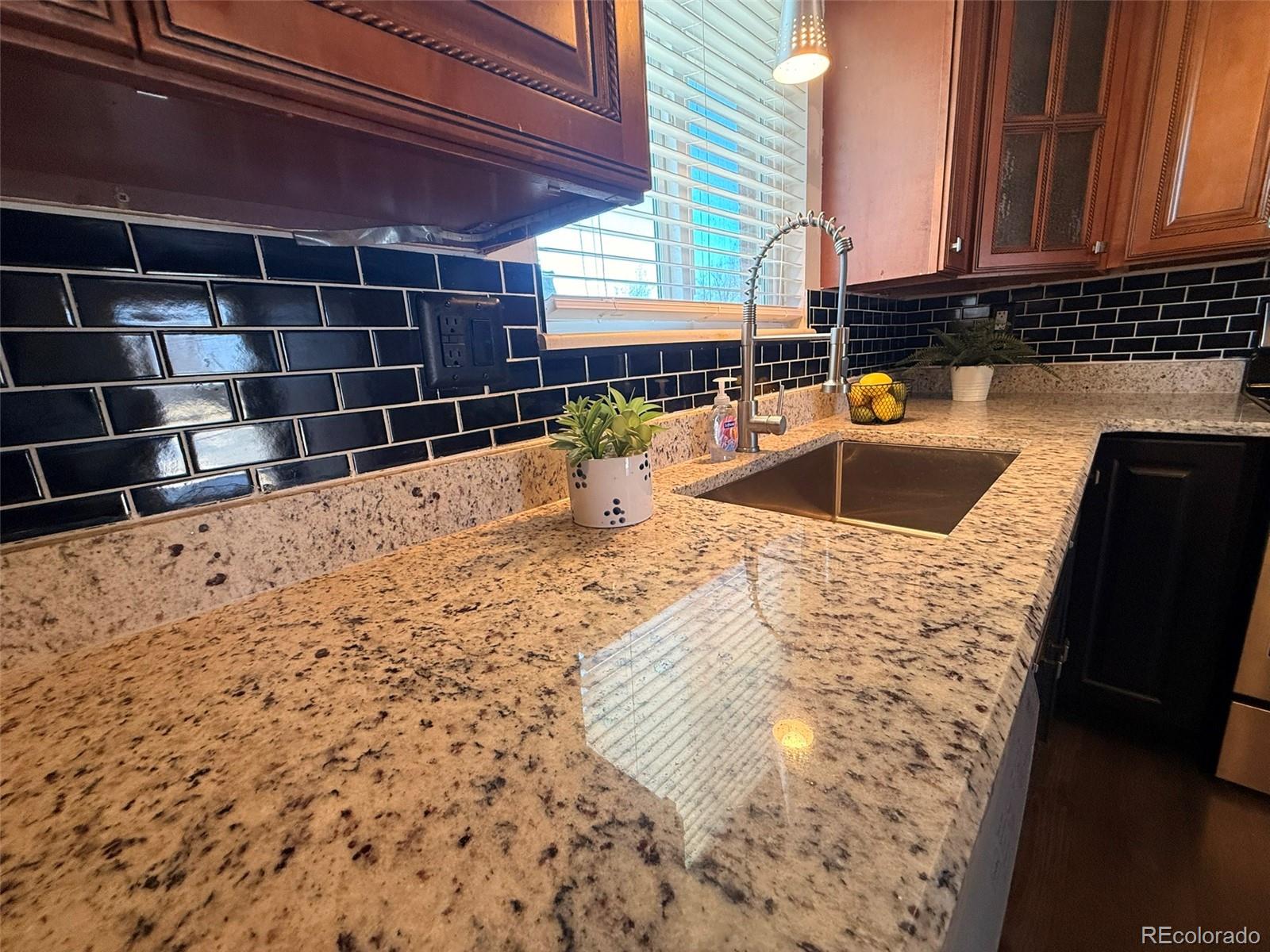 378 South Racine Street Aurora, CO 80012 - Photo 4 of 44 a view of a kitchen with a sink and cabinets