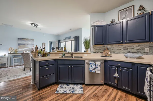 a kitchen with stainless steel appliances granite countertop a sink stove and wooden cabinets
