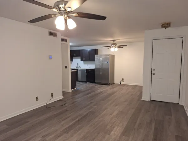 a view of a kitchen with a sink and a refrigerator