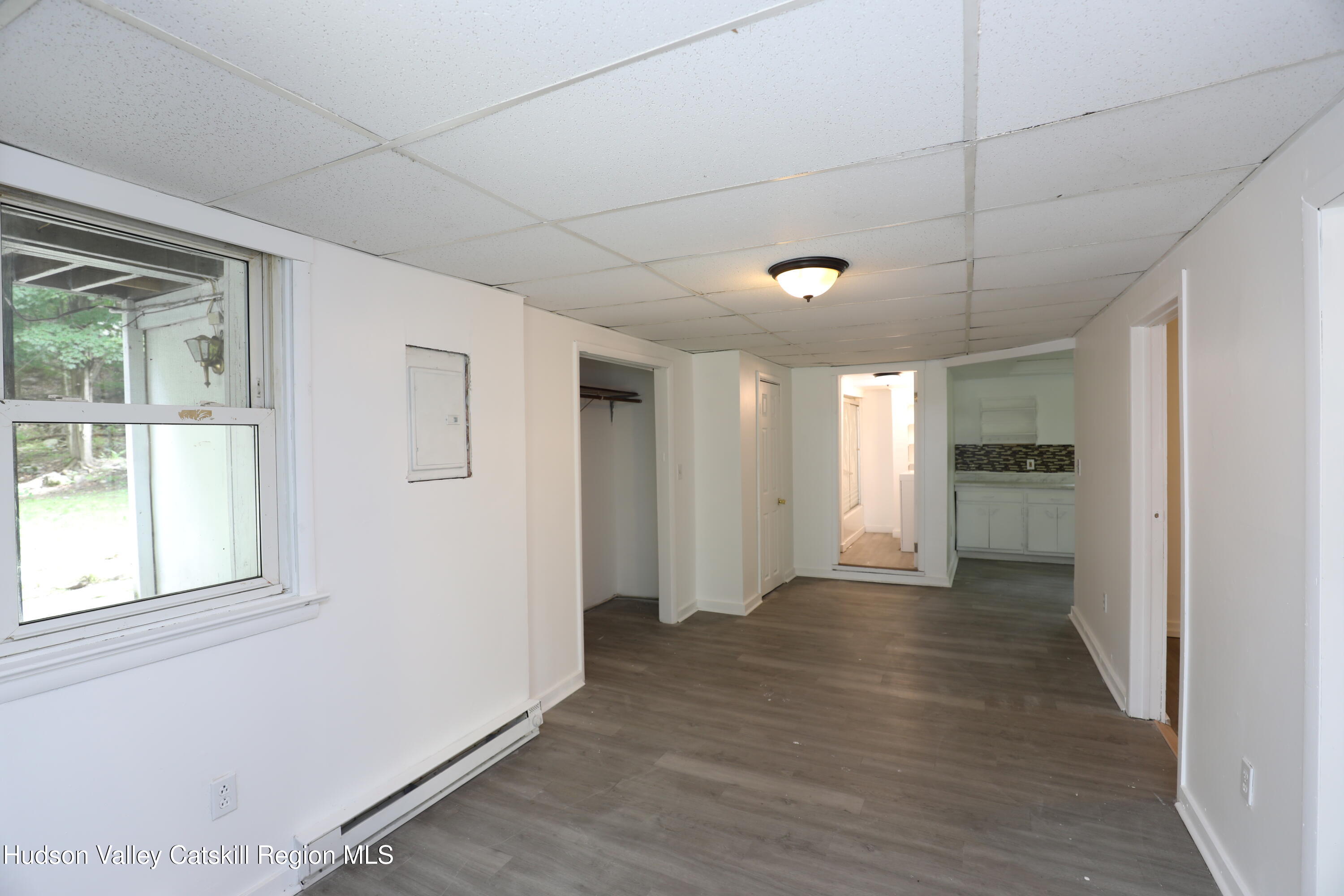 17 Rear Chapel Street, Unit 1 Ellenville, NY 12428 - Photo 4 of 11 a view of an empty room with window and wooden floor
