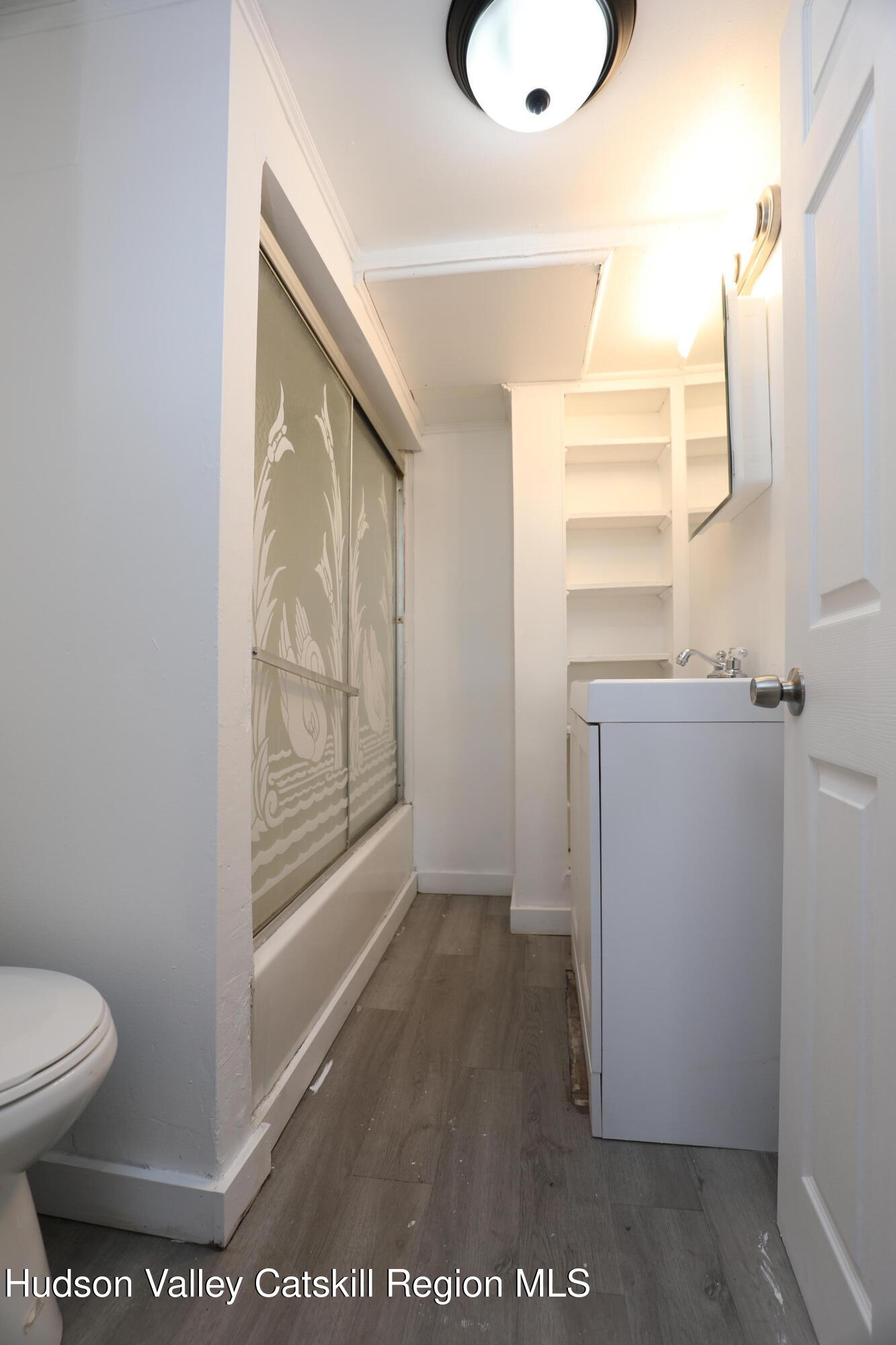 17 Rear Chapel Street, Unit 1 Ellenville, NY 12428 - Photo 9 of 11 a bathroom with a toilet and a shower