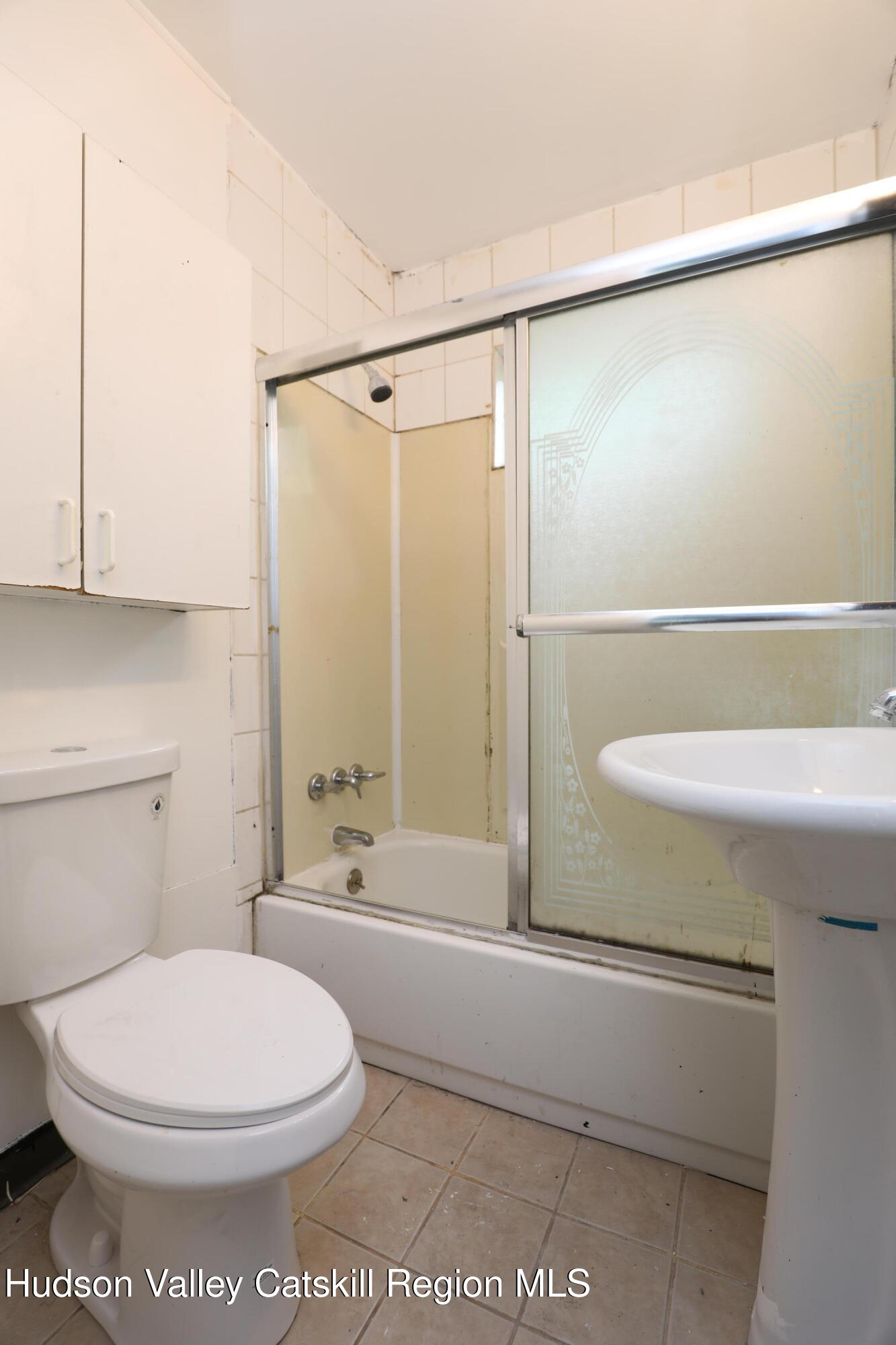 17 Rear Chapel Street, Unit 1 Ellenville, NY 12428 - Photo 10 of 11 a bathroom with a toilet a sink and shower