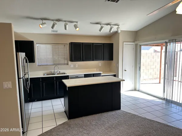 a kitchen with a sink a stove a refrigerator and cabinets