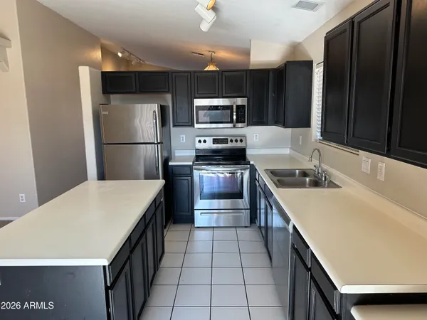 an empty room that has a mirror and a fan