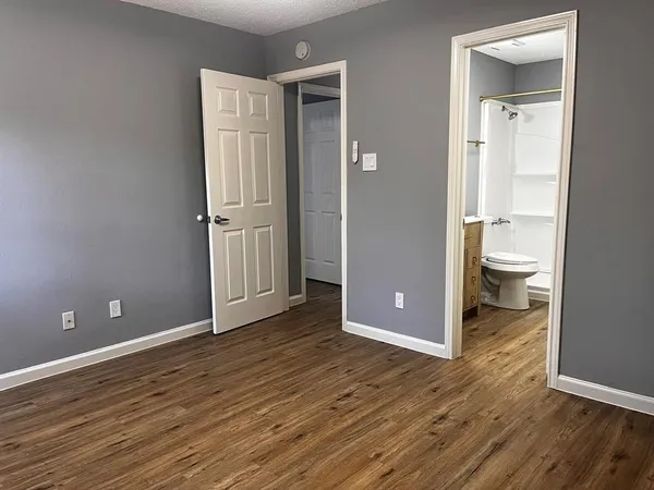 a view of a bathroom with wooden floor and a toilet