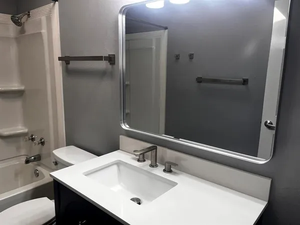 a bathroom with a sink toilet and shower