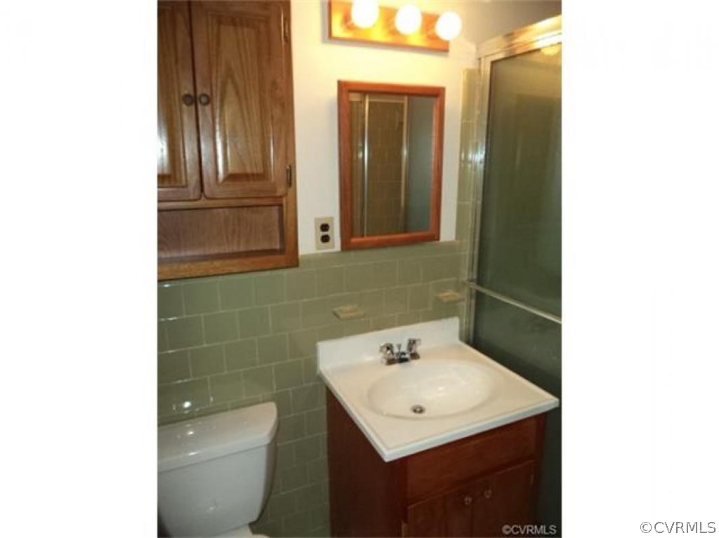 11430 Rochelle Road Chester, VA 23831 - Photo 15 of 21 a bathroom with a sink a toilet and mirror