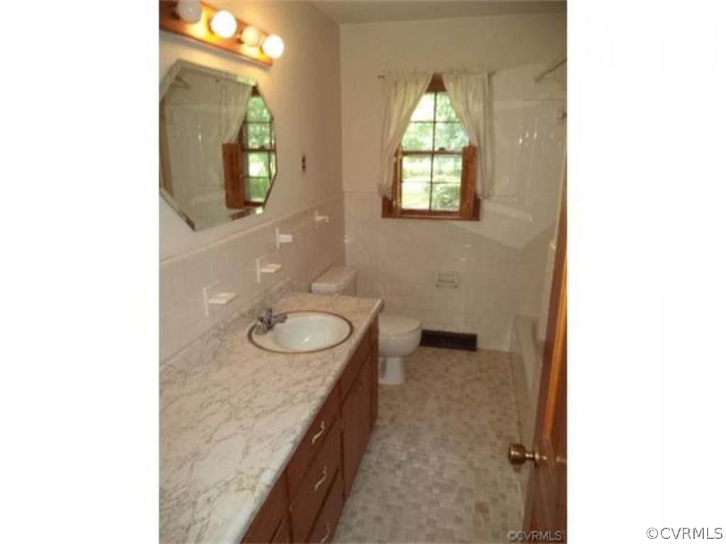 11430 Rochelle Road Chester, VA 23831 - Photo 18 of 21 a bathroom with a granite countertop sink and a mirror