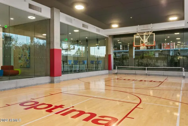 a view of a terrace with lawn chairs and a barbeque