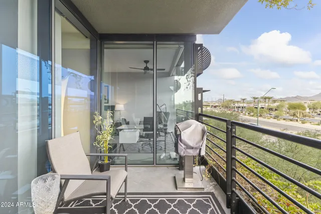a view of a chairs and table in the balcony